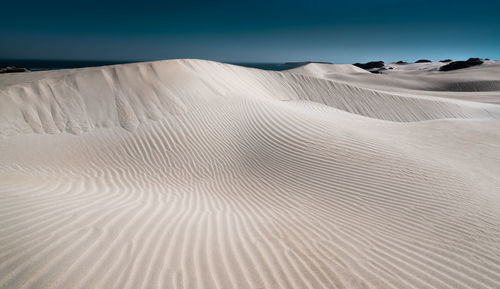 Sand dune in desert against sky