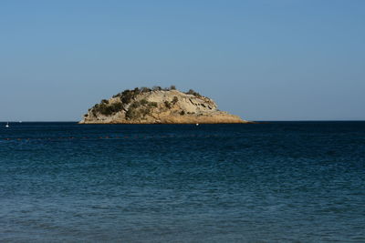 Scenic view of sea against clear blue sky