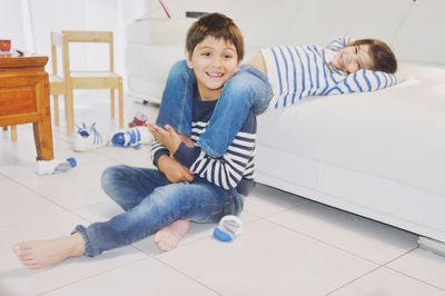 Cheerful sibling sitting at home