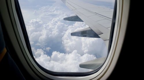 Aerial view of clouds seen through airplane window