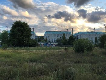 View of factory against cloudy sky