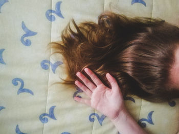 Directly above shot of woman on bed at home