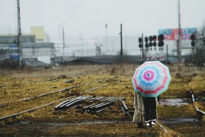 Rear view of women standing against sky