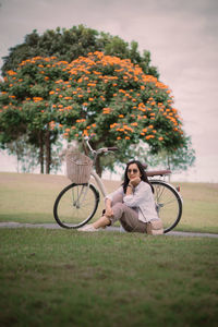 Side view of man riding bicycle on field