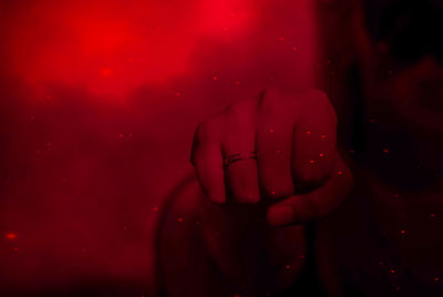 Close-up of hand against red background