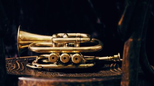 Close-up of golden musical instrument on chair