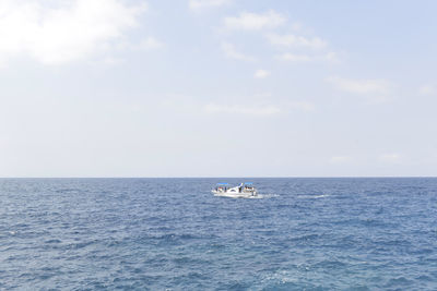 Yacht sailing on sea against sky