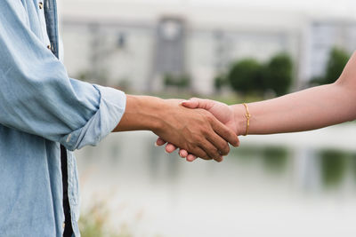 Midsection of man holding hands