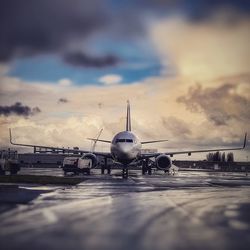 Airplane on runway against sky