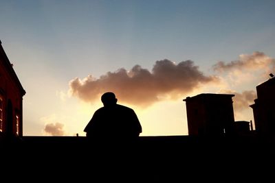 Silhouette man against sky during sunset