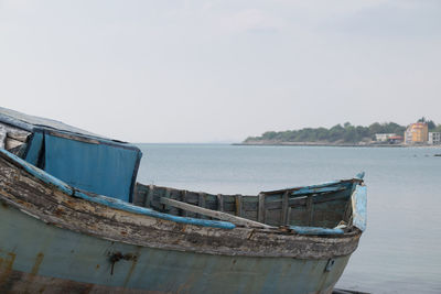 Boat moored on sea against sky