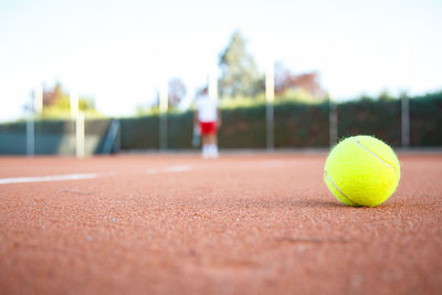 Close-up of yellow ball on tennis field