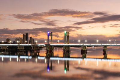 Pier over sea against sky during sunset