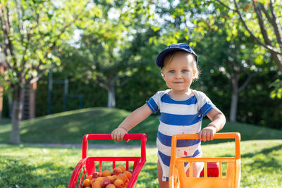 Portrait of cute boy standing standing at park