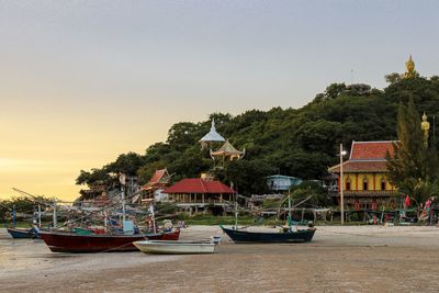 Boats moored in sea against clear sky