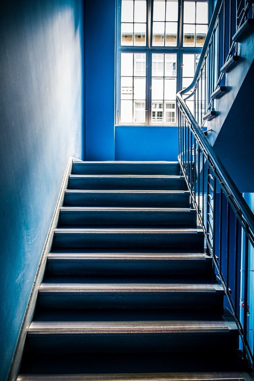 architecture, steps, built structure, staircase, steps and staircases, railing, low angle view, building exterior, indoors, building, blue, stairs, window, modern, no people, day, sunlight, spiral staircase, pattern, residential structure