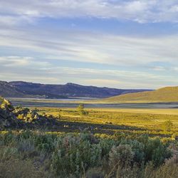 Scenic view of field against cloudy sky