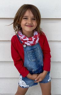 Portrait of young woman standing against wall