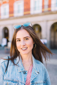 Portrait of smiling young woman in city