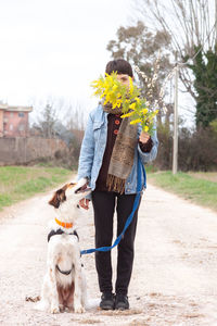 Full length of woman with dog