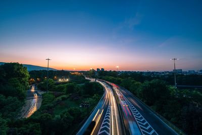 High angle view of light trails on road at sunset