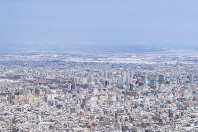 Aerial view of city against sky