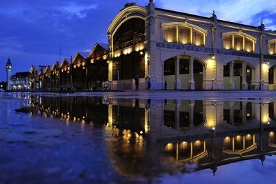 Reflection of building in lake at night