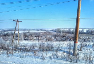 Ski lift against clear sky during winter