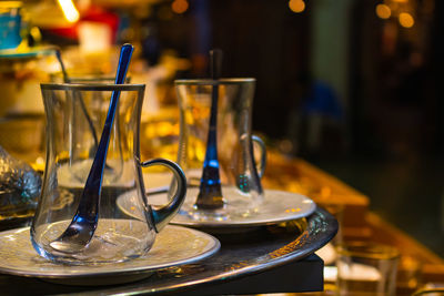 Close-up of illuminated glasses on table