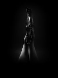 Low section of sensuous legs against black background