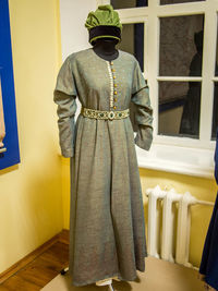 Rear view of man standing against yellow wall