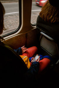 High angle view of woman sitting in train