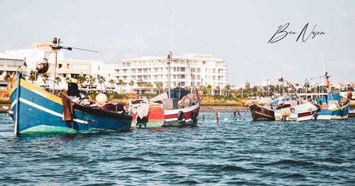 Boats in sea against sky