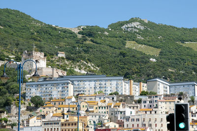 High angle view of townscape and mountains against clear sky