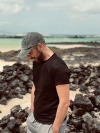 Side view of man standing at beach