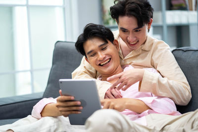 Young woman using digital tablet at home