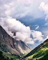 Scenic view of mountains against cloudy sky