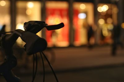 Rear view of man and woman in illuminated street at night