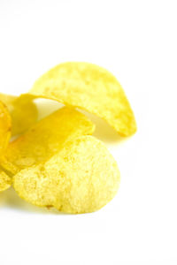 Close-up of bread in plate against white background