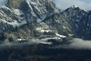 Scenic view of rocky mountains during foggy weather