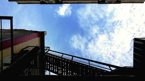 Low angle view of building against cloudy sky