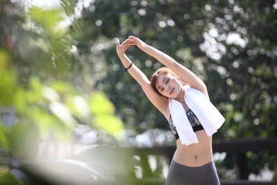 Midsection of woman standing against blurred background