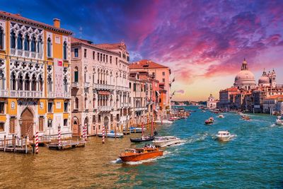 View of buildings in city at sunset