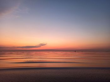 Scenic view of sea against romantic sky at sunrise