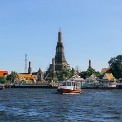 Boats in river with buildings in background