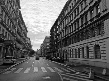 Vehicles on road amidst buildings in city