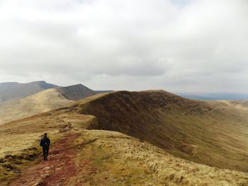 Scenic view of landscape against cloudy sky