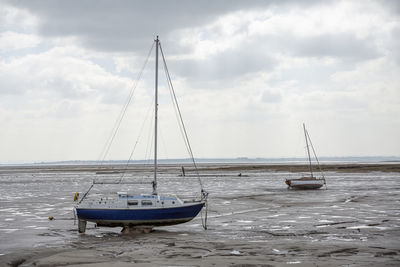 Fisherman boats stuck on the beach in low tide period in leigh-on-sea, uk.