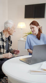 Young woman using laptop at home