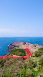 Hundreds of shinto shrine torii gates  on the cliff in yamaguchi, japan